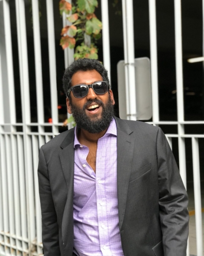 Sankaran in a suit wearing sunglasses